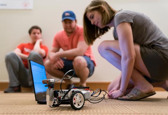 Image of students working collaboratively in a robotics competition.